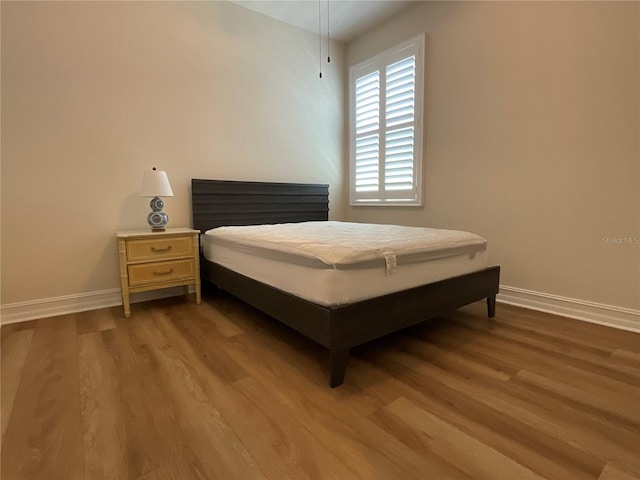 4428 Conchfish Ln, Osprey, FL 34229 - bedroom with wood finished floors and baseboards
