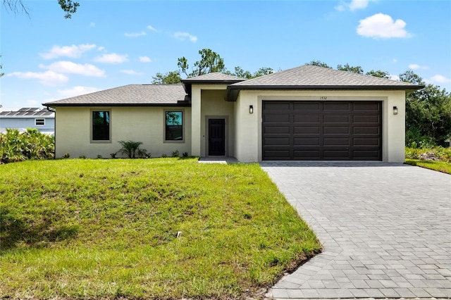 1532 Maricopa Rd, North Port, FL 34287 - view of front of home featuring stucco siding, an attached garage, decorative driveway, and a front lawn