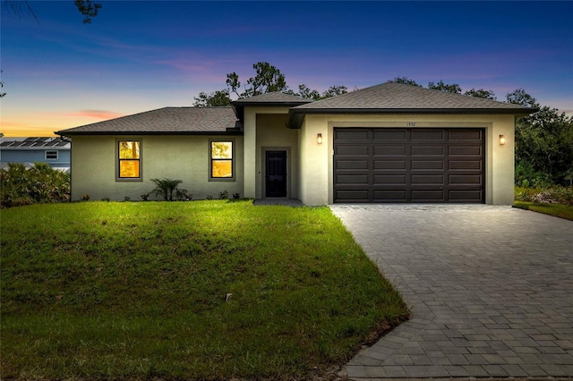 1532 Maricopa Rd, North Port, FL 34287 - view of front of property featuring stucco siding, an attached garage, a lawn, and decorative driveway
