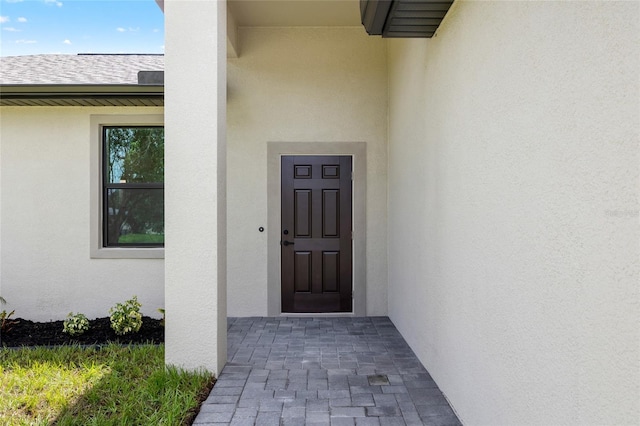 1532 Maricopa Rd, North Port, FL 34287 - doorway to property with stucco siding