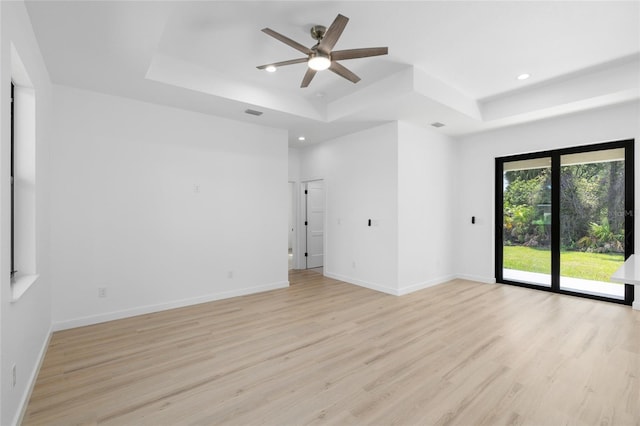 1532 Maricopa Rd, North Port, FL 34287 - spare room with a tray ceiling, light wood-style flooring, a ceiling fan, and recessed lighting