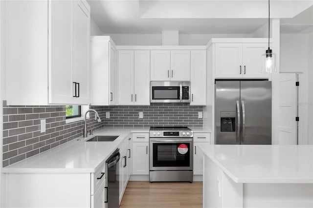 1532 Maricopa Rd, North Port, FL 34287 - kitchen featuring stainless steel appliances, light countertops, light wood-type flooring, white cabinetry, and tasteful backsplash
