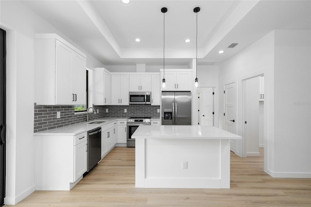 1532 Maricopa Rd, North Port, FL 34287 - kitchen with stainless steel appliances, a raised ceiling, backsplash, white cabinets, and recessed lighting
