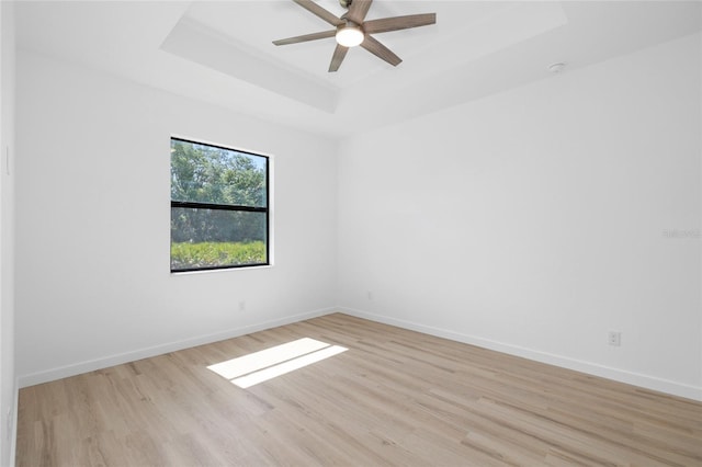 1532 Maricopa Rd, North Port, FL 34287 - unfurnished room with a raised ceiling, light wood-style floors, a ceiling fan, and a smoke detector