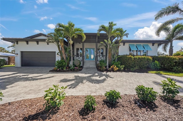 5569 Cape Leyte Dr, Sarasota, FL 34242 - view of front facade with stucco siding, decorative driveway, and an attached garage