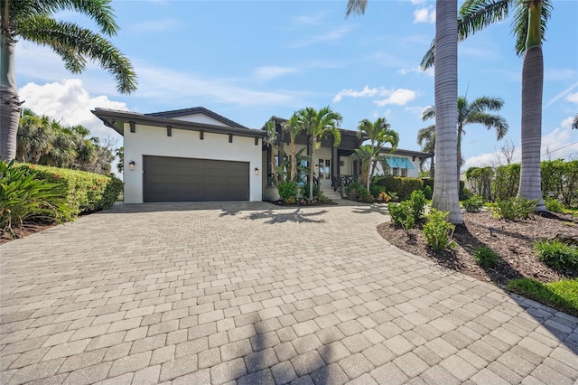 5569 Cape Leyte Dr, Sarasota, FL 34242 - view of front facade with decorative driveway, stucco siding, and an attached garage