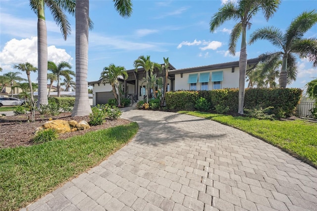 5569 Cape Leyte Dr, Sarasota, FL 34242 - view of front of property featuring decorative driveway, a garage, and stucco siding