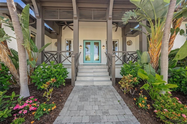 5569 Cape Leyte Dr, Sarasota, FL 34242 - doorway to property featuring stucco siding, covered porch, and french doors