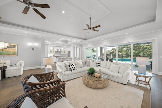 5569 Cape Leyte Dr, Sarasota, FL 34242 - living room featuring a ceiling fan, a tray ceiling, wood finished floors, recessed lighting, and ornamental molding