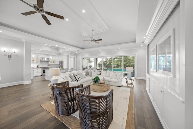 5569 Cape Leyte Dr, Sarasota, FL 34242 - living room featuring a ceiling fan, a tray ceiling, hardwood / wood-style flooring, recessed lighting, and ornamental molding