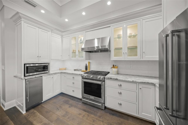 5569 Cape Leyte Dr, Sarasota, FL 34242 - kitchen featuring appliances with stainless steel finishes, wall chimney exhaust hood, dark wood-style floors, white cabinets, and recessed lighting