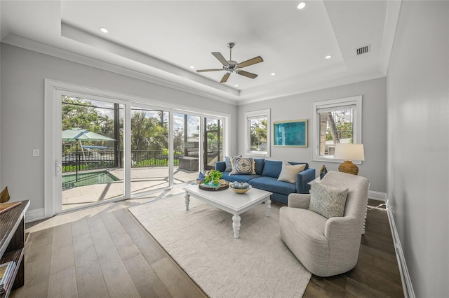 5569 Cape Leyte Dr, Sarasota, FL 34242 - living area with a tray ceiling, wood-type flooring, ceiling fan, and recessed lighting