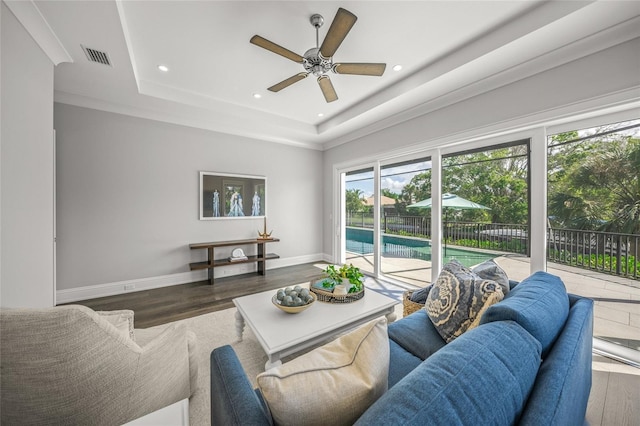 5569 Cape Leyte Dr, Sarasota, FL 34242 - living area with ceiling fan, recessed lighting, a raised ceiling, and wood finished floors