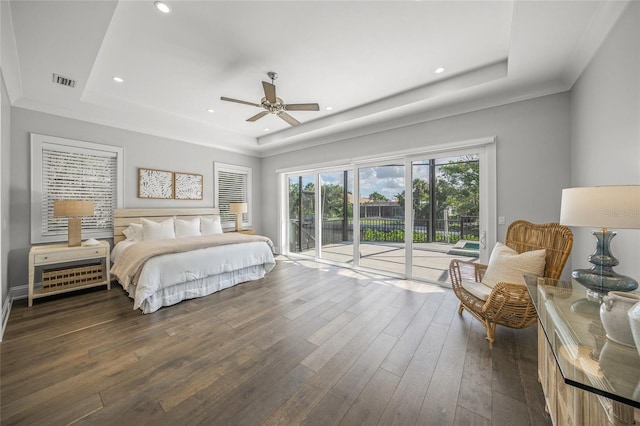 5569 Cape Leyte Dr, Sarasota, FL 34242 - bedroom with a tray ceiling, access to exterior, dark wood-style flooring, a ceiling fan, and recessed lighting