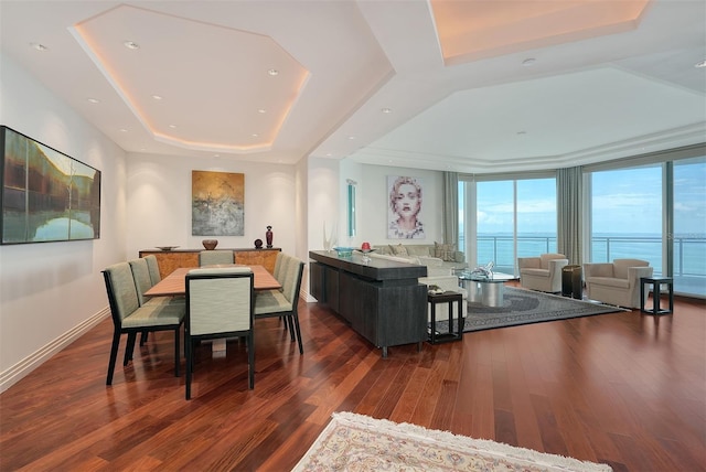 990 Blvd Of The Arts Unit 801, Sarasota, FL 34236 - dining space featuring a tray ceiling and wood finished floors
