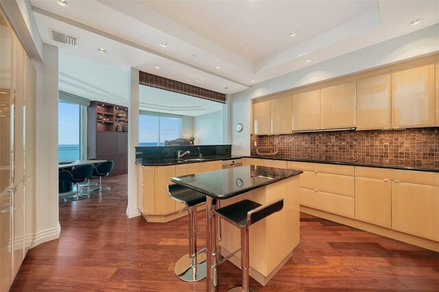 990 Blvd Of The Arts Unit 801, Sarasota, FL 34236 - kitchen featuring light brown cabinets, dark wood finished floors, backsplash, and recessed lighting
