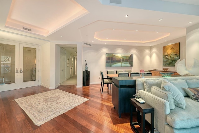 990 Blvd Of The Arts Unit 801, Sarasota, FL 34236 - living room with a tray ceiling, wood finished floors, french doors, and recessed lighting