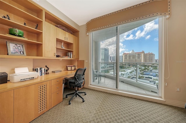 990 Blvd Of The Arts Unit 801, Sarasota, FL 34236 - home office with built in study area, light colored carpet, and a city view