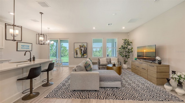 491 Daylily Blvd, Nokomis, FL 34275 - living area featuring a chandelier, recessed lighting, and light wood-style flooring