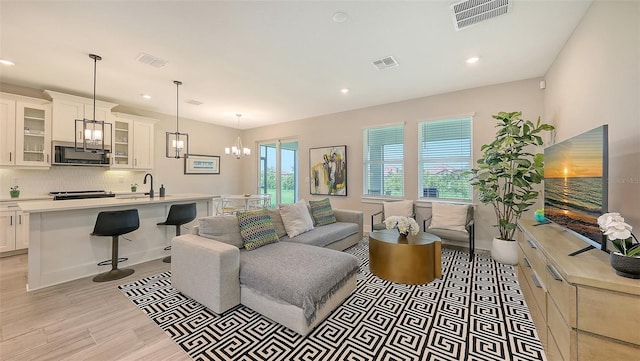 491 Daylily Blvd, Nokomis, FL 34275 - living area with a chandelier, light wood-type flooring, and recessed lighting