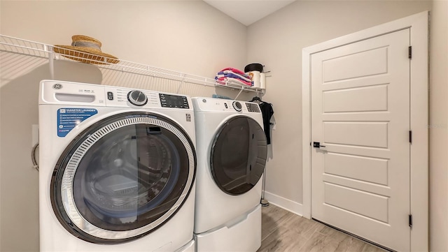 491 Daylily Blvd, Nokomis, FL 34275 - laundry room with washer and clothes dryer and light wood-type flooring