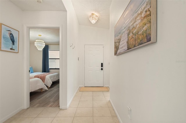 4411 46th Ave W Unit 201, Bradenton, FL 34210 - corridor featuring light tile patterned floors and a textured ceiling