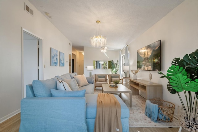4411 46th Ave W Unit 201, Bradenton, FL 34210 - living area featuring wood finished floors, a chandelier, and a ceiling fan