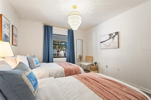 4411 46th Ave W Unit 201, Bradenton, FL 34210 - bedroom featuring a chandelier and baseboards