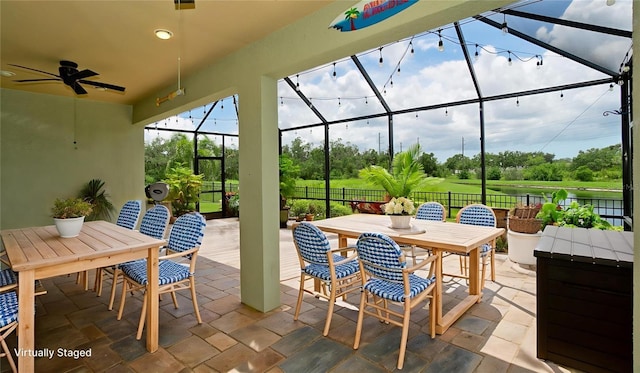7364 47th Avenue Cir E, Bradenton, FL 34203 - view of patio / terrace with outdoor dining space, a lanai, ceiling fan, and view of scattered trees