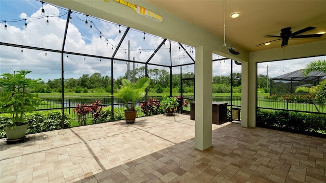 7364 47th Avenue Cir E, Bradenton, FL 34203 - view of patio / terrace featuring glass enclosure, a ceiling fan, and view of scattered trees