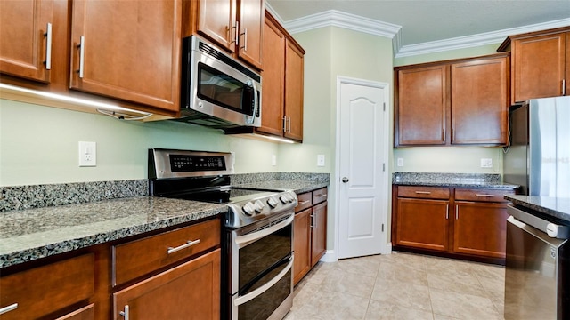 7364 47th Avenue Cir E, Bradenton, FL 34203 - kitchen with stainless steel appliances, dark stone countertops, crown molding, and brown cabinets