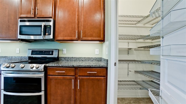 7364 47th Avenue Cir E, Bradenton, FL 34203 - kitchen featuring appliances with stainless steel finishes and dark stone counters
