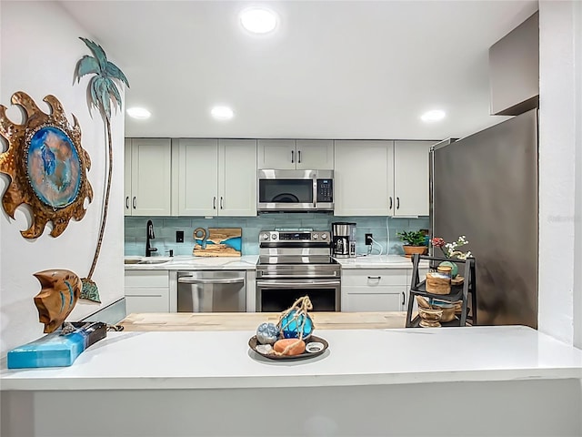 3700 S Osprey Ave Unit 122, Sarasota, FL 34239 - kitchen with appliances with stainless steel finishes, light countertops, backsplash, and recessed lighting