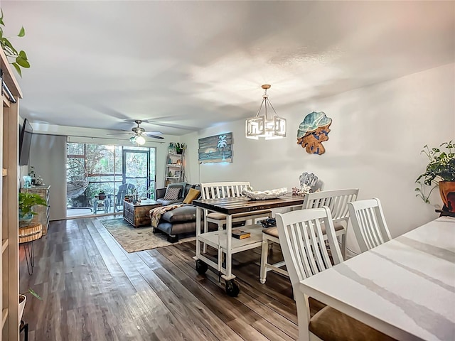 3700 S Osprey Ave Unit 122, Sarasota, FL 34239 - dining space with wood finished floors, a ceiling fan, and a chandelier