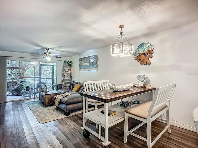 3700 S Osprey Ave Unit 122, Sarasota, FL 34239 - dining area with wood finished floors, a ceiling fan, and a chandelier