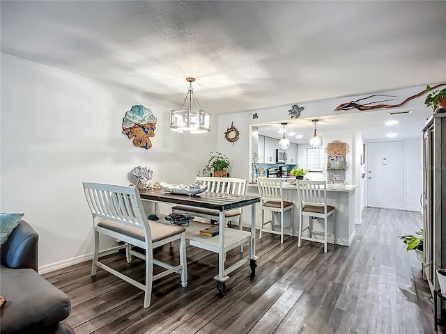 3700 S Osprey Ave Unit 122, Sarasota, FL 34239 - dining space featuring wood finished floors and a chandelier