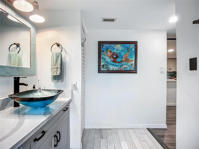 3700 S Osprey Ave Unit 122, Sarasota, FL 34239 - bathroom featuring wood finished floors and vanity