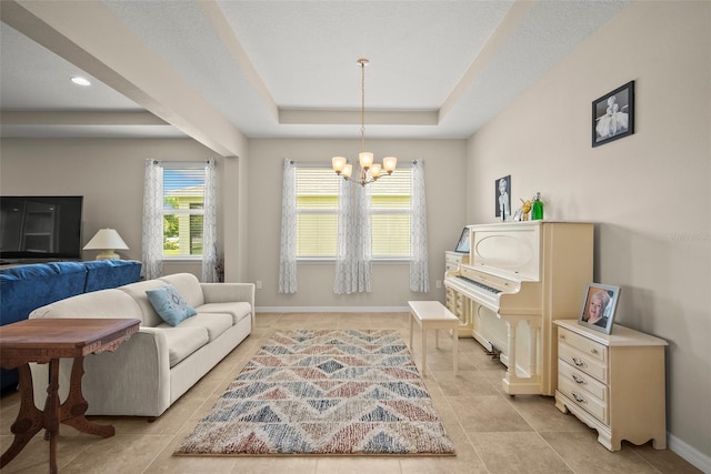 226 Tapa Parish Run, Bradenton, FL 34212 - living area with a tray ceiling, a chandelier, and light tile patterned floors