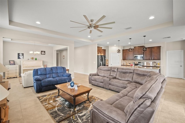 226 Tapa Parish Run, Bradenton, FL 34212 - living area featuring a raised ceiling, light tile patterned floors, ceiling fan, a chandelier, and recessed lighting