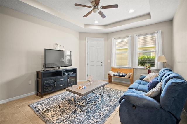 226 Tapa Parish Run, Bradenton, FL 34212 - living area with a ceiling fan, a tray ceiling, and light tile patterned floors