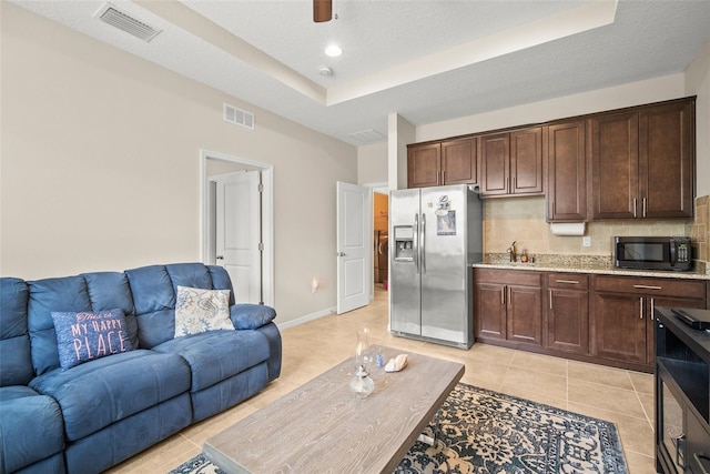 226 Tapa Parish Run, Bradenton, FL 34212 - living area featuring a raised ceiling and light tile patterned flooring