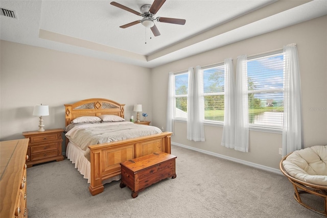 226 Tapa Parish Run, Bradenton, FL 34212 - bedroom with light carpet, a tray ceiling, and ceiling fan