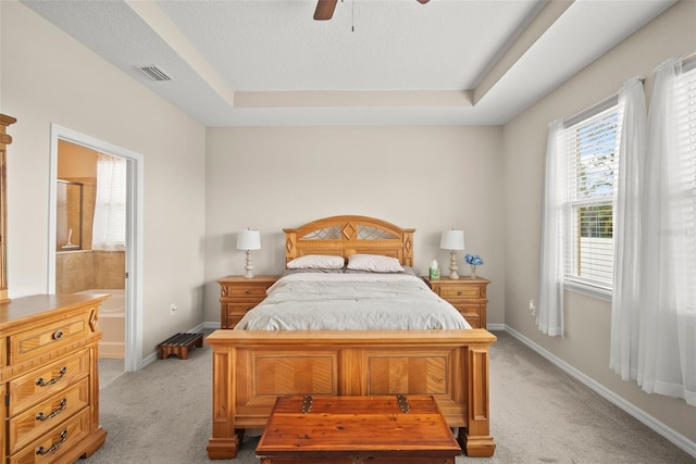 226 Tapa Parish Run, Bradenton, FL 34212 - bedroom featuring light carpet, ensuite bath, a raised ceiling, and ceiling fan