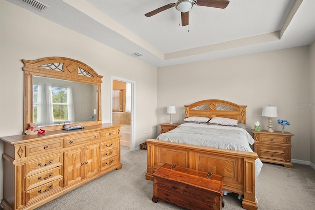 226 Tapa Parish Run, Bradenton, FL 34212 - bedroom featuring light carpet, ensuite bathroom, a raised ceiling, and a ceiling fan