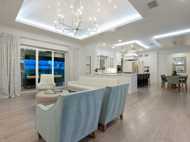 5630 Inspiration Ter, Bradenton, FL 34210 - living area featuring a raised ceiling, light wood-style flooring, a chandelier, and recessed lighting