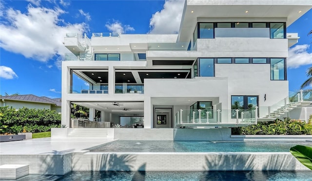 1610 N Lodge Dr, Sarasota, FL 34239 - rear view of property with stucco siding, a balcony, a carport, an infinity pool, and a ceiling fan