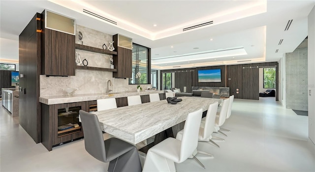 1610 N Lodge Dr, Sarasota, FL 34239 - dining room with a tray ceiling, finished concrete floors, and plenty of natural light