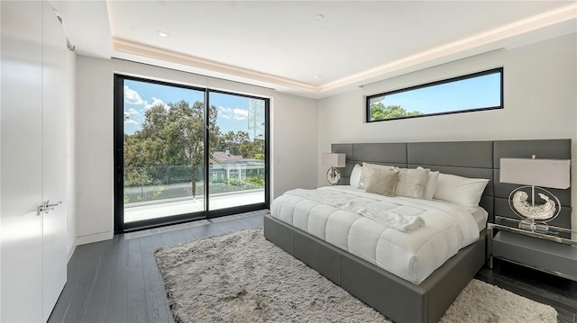 1610 N Lodge Dr, Sarasota, FL 34239 - bedroom featuring a raised ceiling, access to outside, and hardwood / wood-style floors