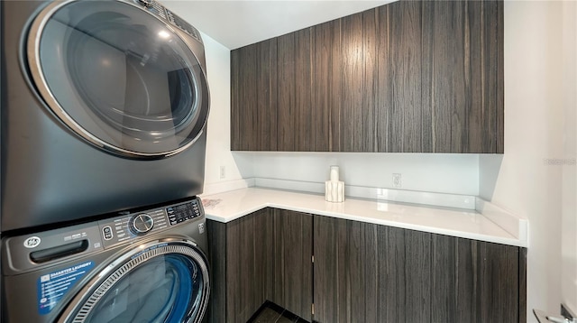 1610 N Lodge Dr, Sarasota, FL 34239 - washroom with stacked washer and clothes dryer and cabinet space