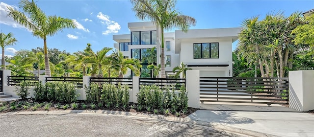 1610 N Lodge Dr, Sarasota, FL 34239 - contemporary home featuring a fenced front yard, stucco siding, and driveway